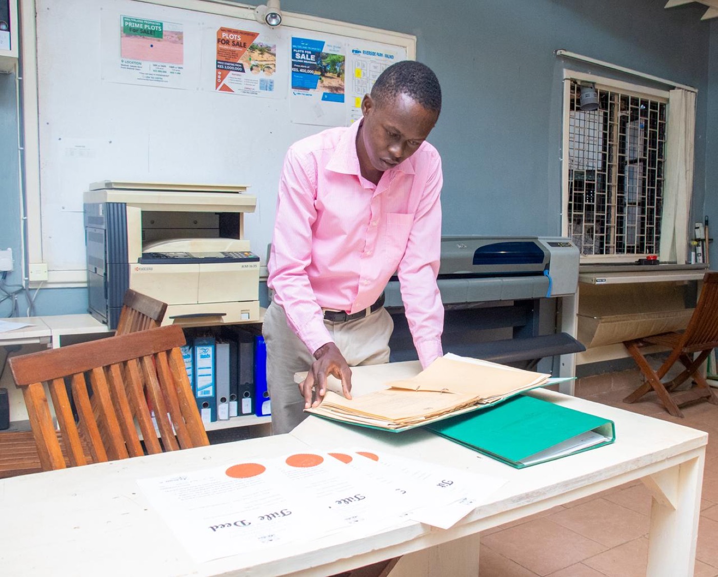 Surveyor reviewing cadastral maps in office